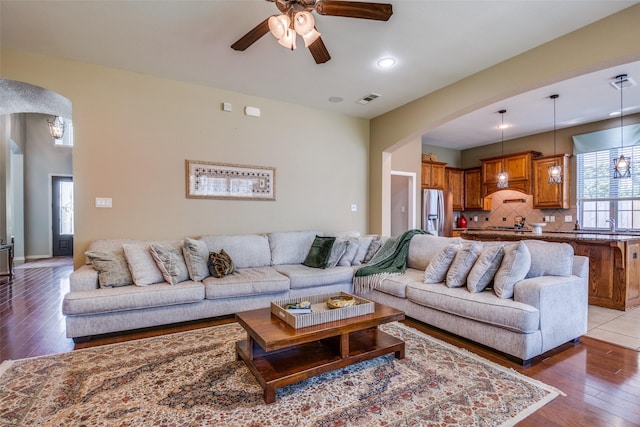 9720 Birdville Way, Fort Worth, TX 76244 - living room with arched walkways, a ceiling fan, and light wood-style flooring