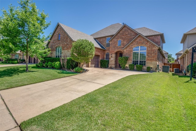 9720 Birdville Way, Fort Worth, TX 76244 - traditional-style house with brick siding, an attached garage, roof with shingles, concrete driveway, and central AC unit