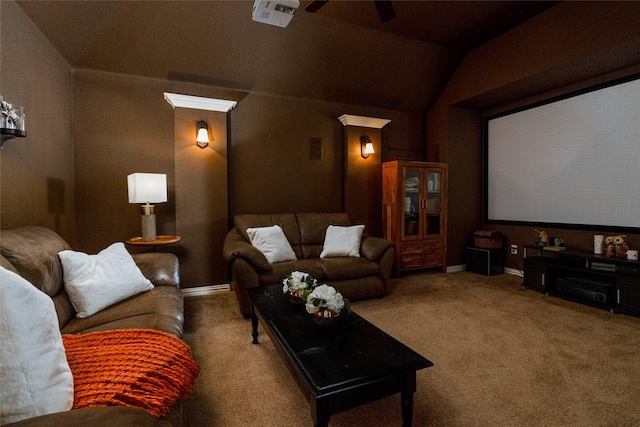 carpeted home theater room with lofted ceiling