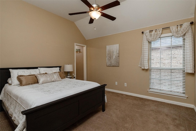 bedroom with ceiling fan, lofted ceiling, and carpet flooring