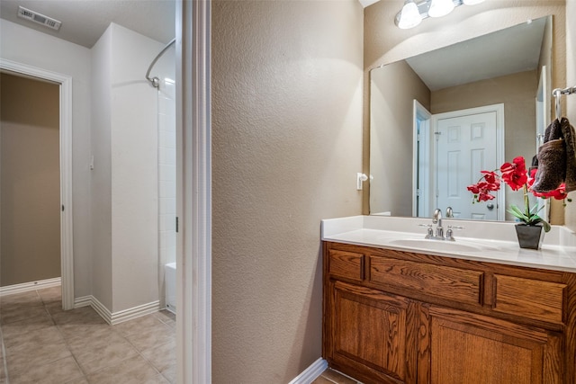 9720 Birdville Way, Fort Worth, TX 76244 - full bathroom with vanity, baseboards, tile patterned floors, and a textured wall