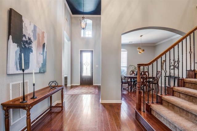 9720 Birdville Way, Fort Worth, TX 76244 - foyer with arched walkways, crown molding, wood-type flooring, stairway, and baseboards