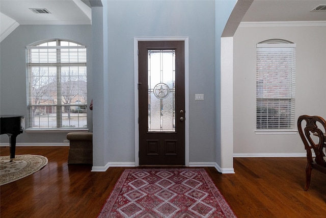 entryway with dark wood-type flooring and ornamental molding