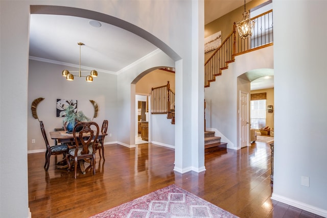 9720 Birdville Way, Fort Worth, TX 76244 - dining room with wood finished floors, stairs, baseboards, crown molding, and arched walkways