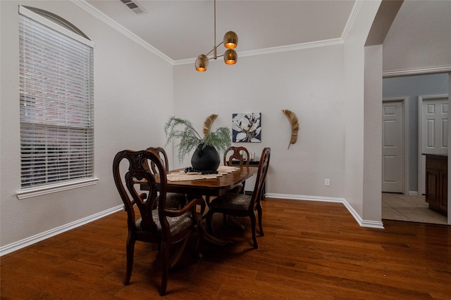 dining space featuring crown molding and dark hardwood / wood-style floors