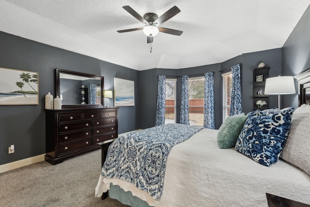 carpeted bedroom with ceiling fan and a textured ceiling