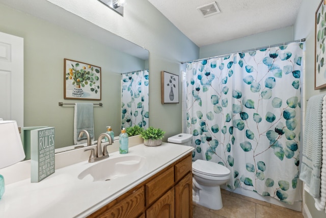 full bathroom featuring tile patterned flooring, vanity, shower / tub combo with curtain, and toilet