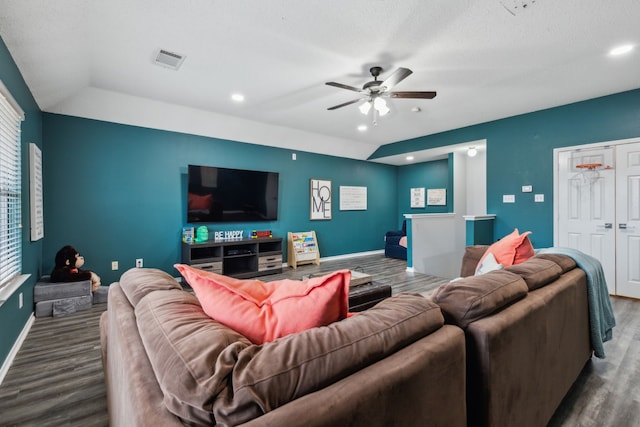 living room featuring ceiling fan, wood-type flooring, a textured ceiling, and lofted ceiling