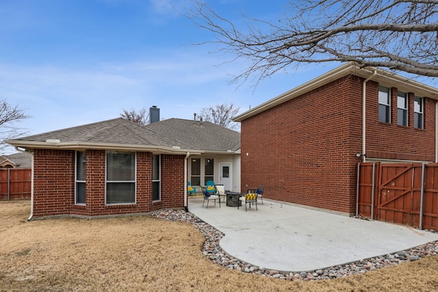 back of property featuring a patio and a lawn