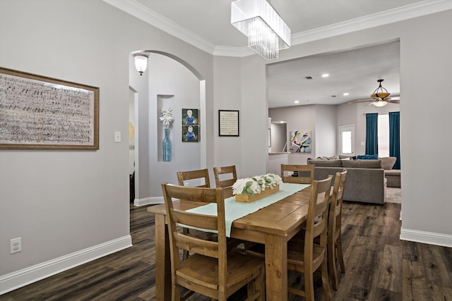 dining room featuring crown molding, ceiling fan with notable chandelier, and dark hardwood / wood-style floors