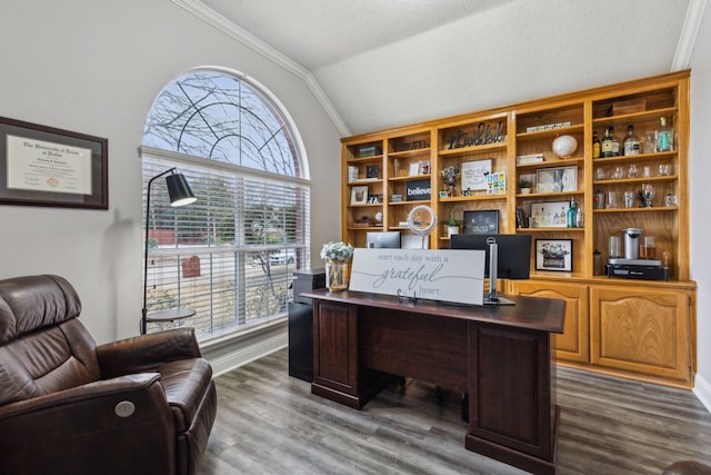 office space with ornamental molding, vaulted ceiling, and hardwood / wood-style floors