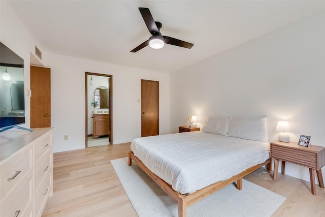 bedroom with light hardwood / wood-style floors, ceiling fan, and ensuite bathroom