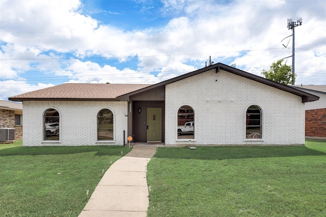 view of front of house featuring a front yard and central AC unit