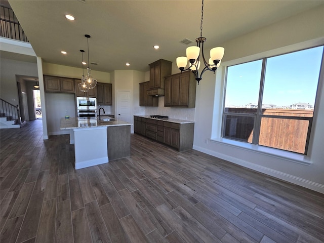 kitchen with recessed lighting, dark wood-style floors, under cabinet range hood, stainless steel appliances, and visible vents
