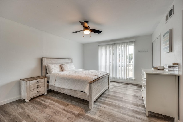 bedroom with hardwood / wood-style flooring and ceiling fan