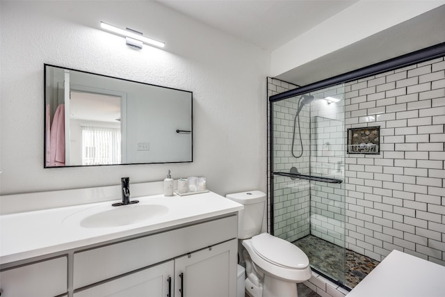 bathroom with vanity, toilet, and an enclosed shower