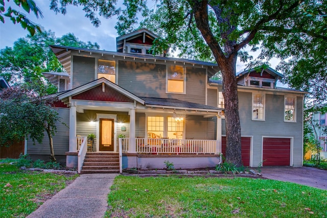 view of front facade with a garage, a front yard, and a porch