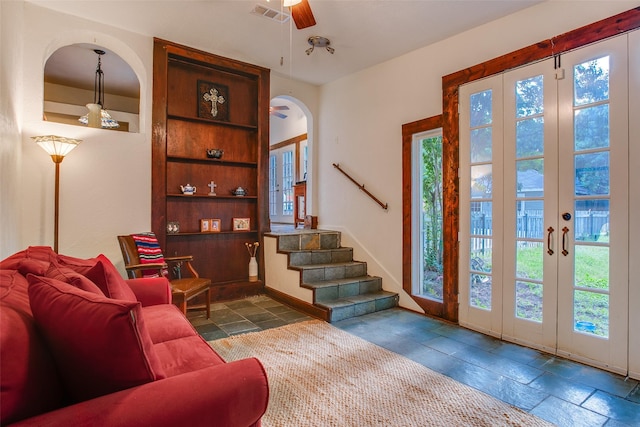 entrance foyer with french doors, ceiling fan, and a healthy amount of sunlight