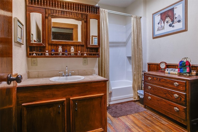 bathroom with vanity, wood-type flooring, and shower / bath combo