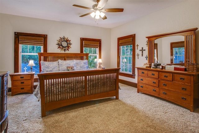 bedroom with ceiling fan and light carpet