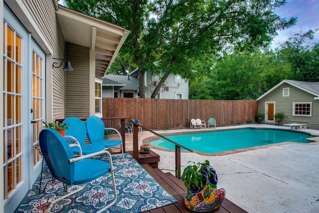 view of pool featuring an outdoor structure and a patio area