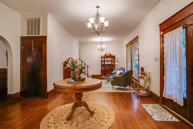 entrance foyer with wood-type flooring and a chandelier