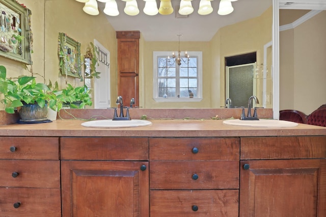 bathroom featuring an enclosed shower, vanity, crown molding, and a chandelier