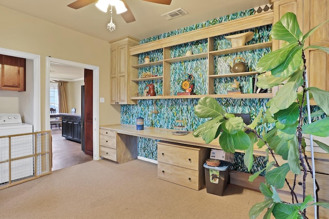 office featuring ceiling fan, washer / dryer, and light carpet