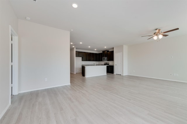 unfurnished living room featuring light hardwood / wood-style floors and ceiling fan