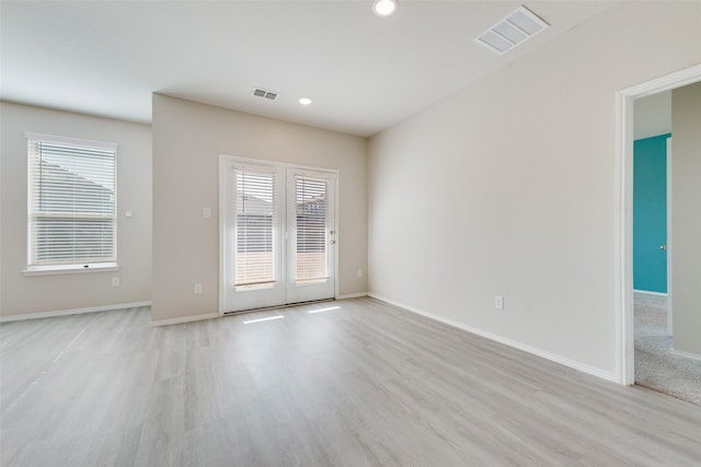 spare room featuring light hardwood / wood-style floors