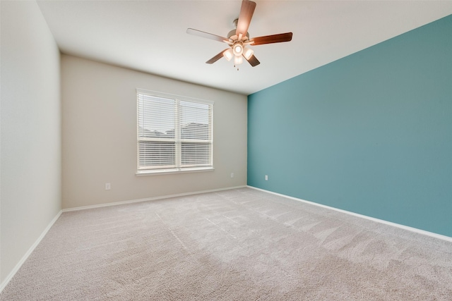 unfurnished room with ceiling fan and light carpet