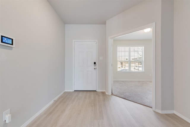 entryway with light wood-style floors and baseboards