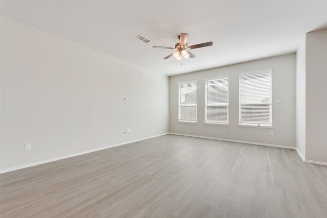 spare room with ceiling fan and light wood-type flooring