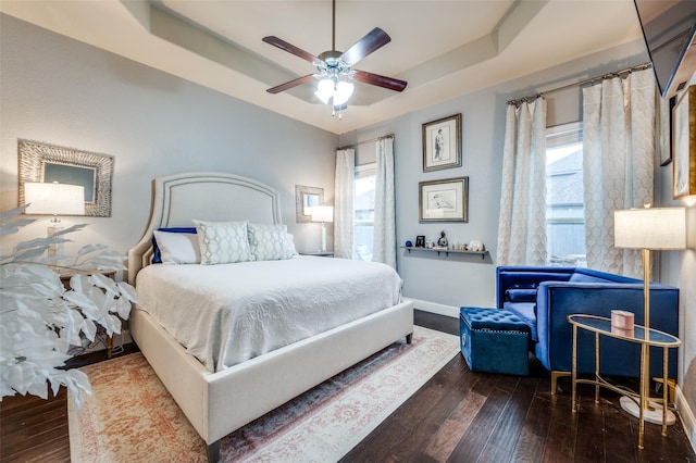 15805 Rockingham St, Frisco, TX 75036 - bedroom with a tray ceiling, multiple windows, wood-type flooring, and baseboards