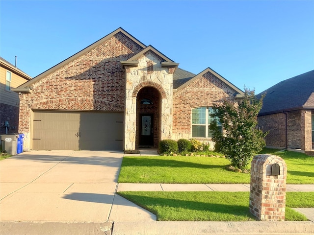 15805 Rockingham St, Frisco, TX 75036 - view of front of home with brick siding, stone siding, a front lawn, driveway, and a garage