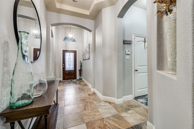 15805 Rockingham St, Frisco, TX 75036 - entryway with arched walkways, baseboards, stone tile flooring, and a textured wall
