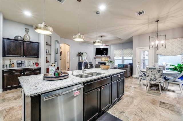 15805 Rockingham St, Frisco, TX 75036 - kitchen featuring stainless steel dishwasher, a sink, arched walkways, a center island with sink, and open floor plan