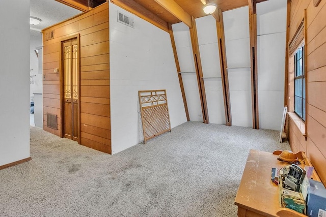 interior space with carpet flooring and wood walls