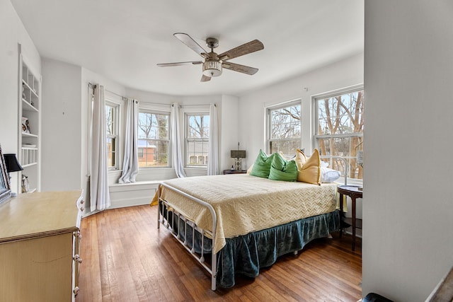 bedroom with wood-type flooring and ceiling fan