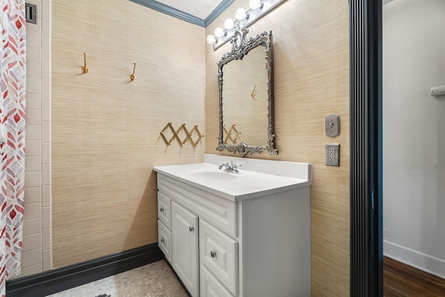 bathroom with ornamental molding and vanity