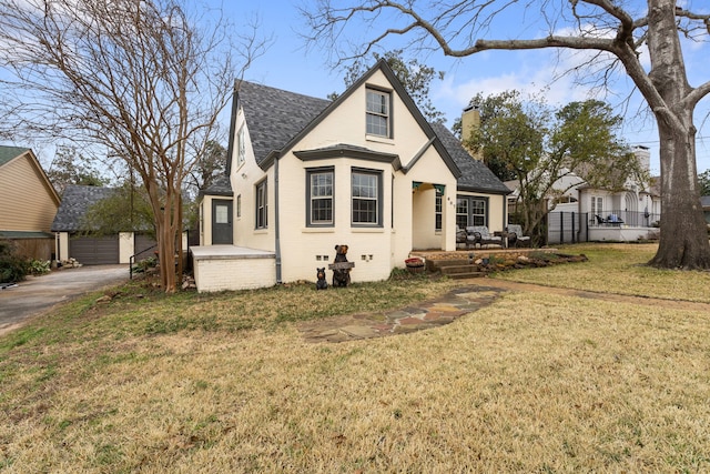 view of front of home with a garage and a front lawn