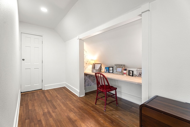 office space with built in desk, dark hardwood / wood-style floors, and vaulted ceiling