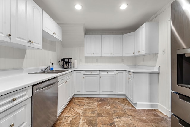 kitchen featuring stainless steel appliances, white cabinetry, and sink