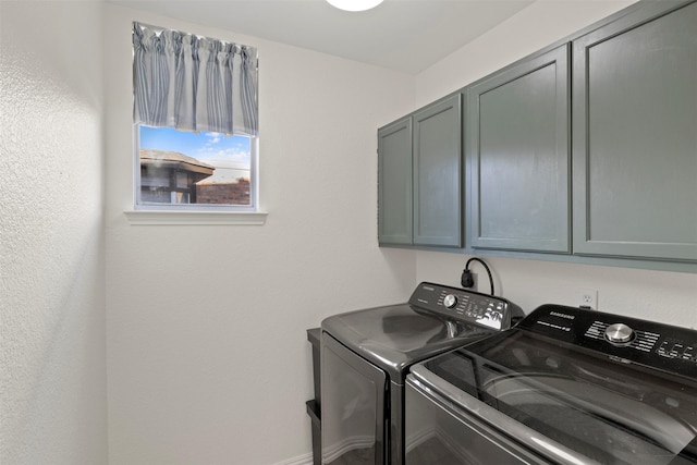 laundry room with cabinets and washing machine and dryer