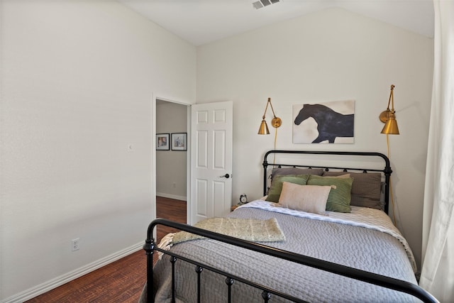 bedroom with dark hardwood / wood-style floors and vaulted ceiling