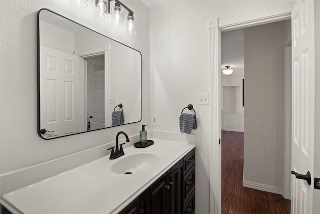 bathroom with vanity and hardwood / wood-style flooring