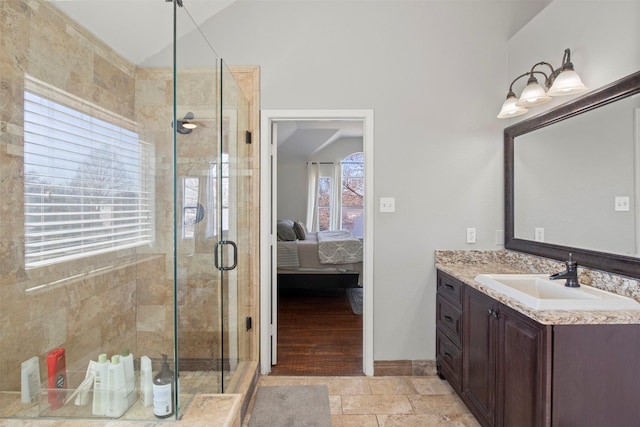 bathroom with vanity, an enclosed shower, and vaulted ceiling