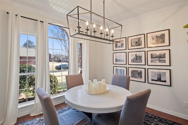 dining room featuring dark wood-type flooring, ornamental molding, and plenty of natural light