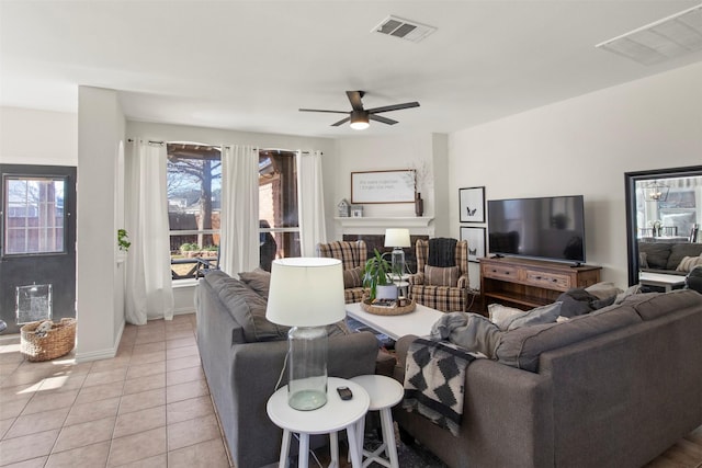 living room with light tile patterned floors and ceiling fan