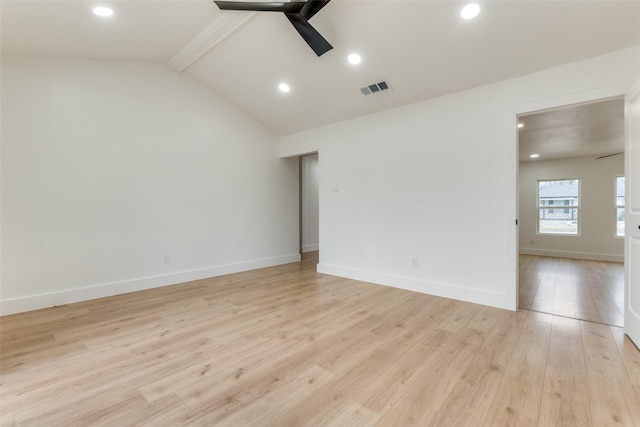 empty room with ceiling fan, lofted ceiling with beams, and light hardwood / wood-style flooring